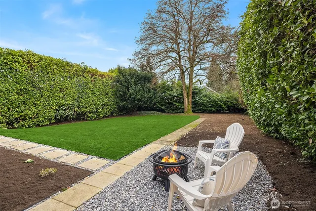 a view of backyard with outdoor seating and green space