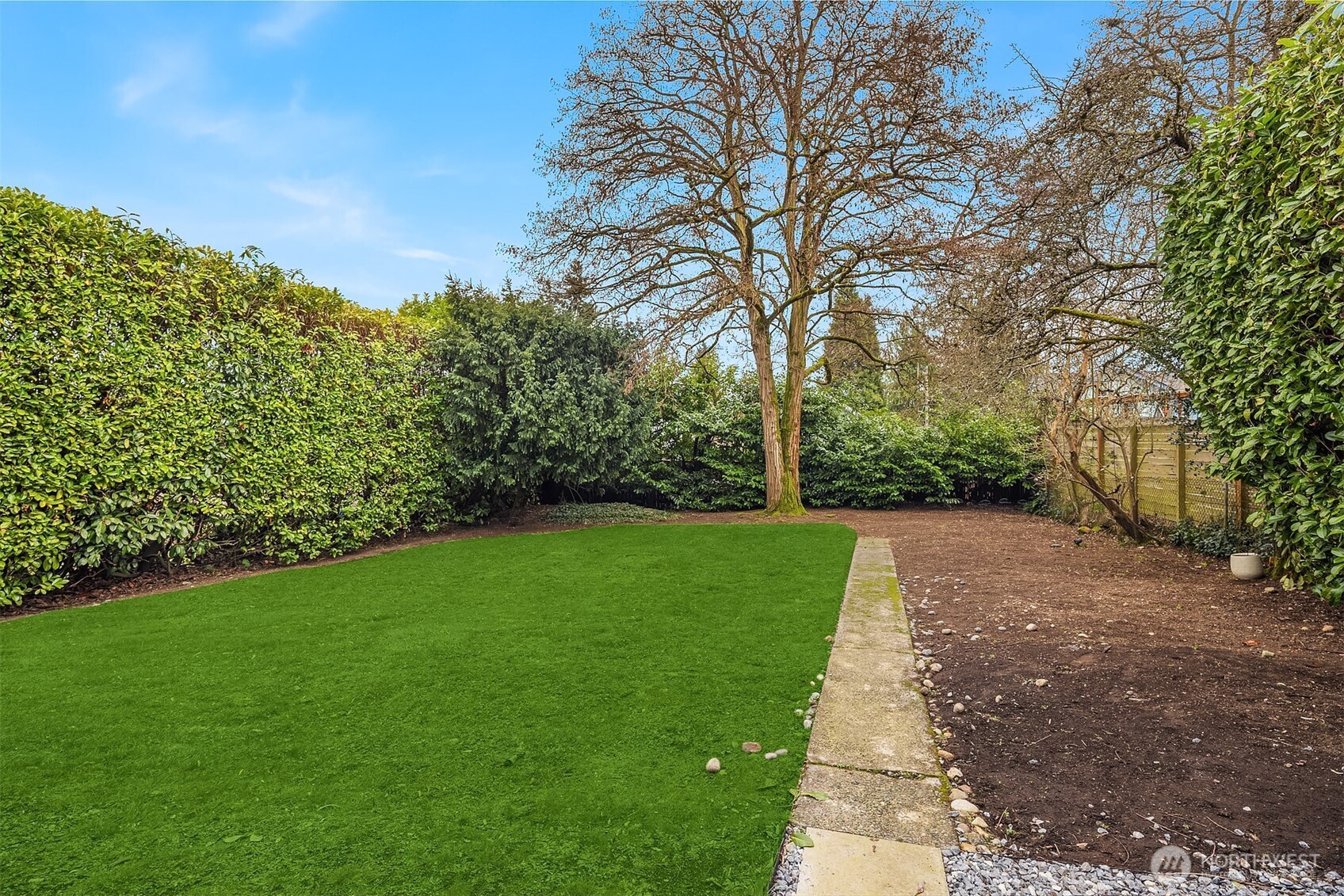 721 North 97th Street Seattle, WA 98103 - Photo 30 of 35 a view of a yard with a tree