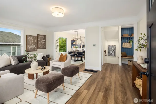 a living room with furniture and a wooden floor