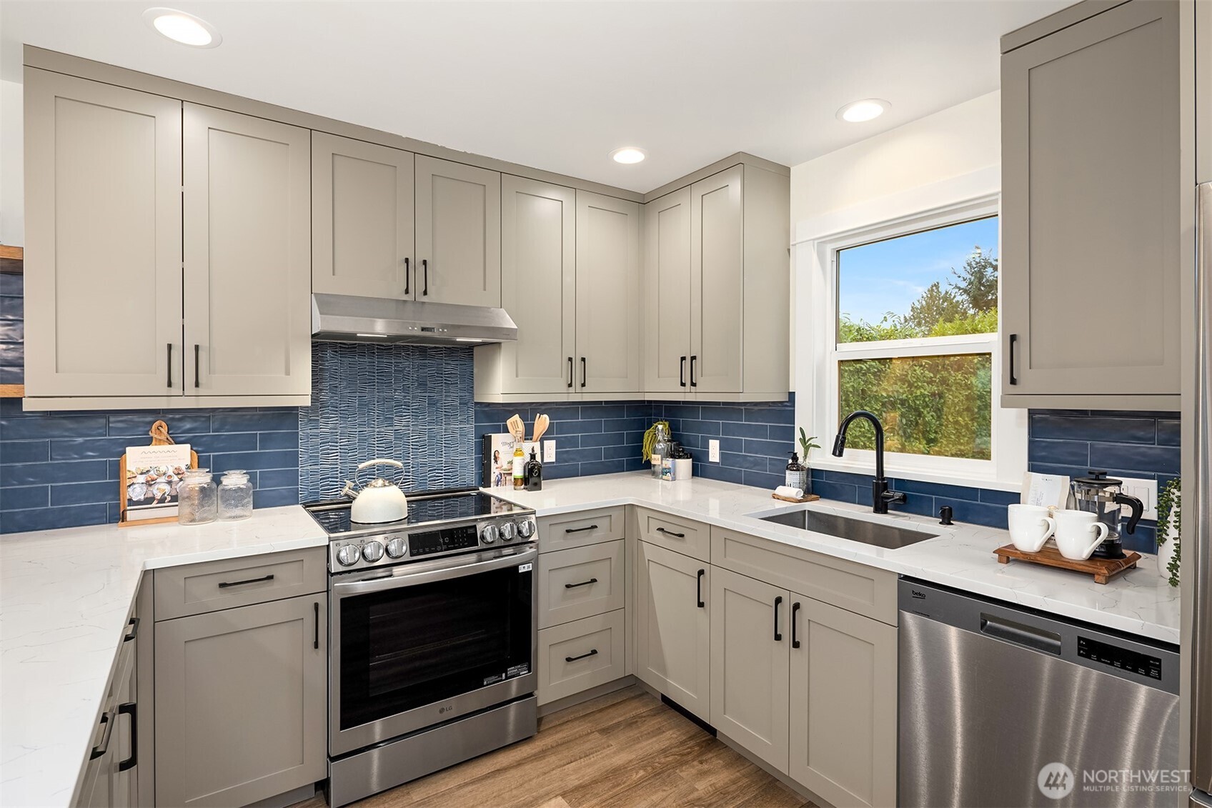 721 North 97th Street Seattle, WA 98103 - Photo 10 of 35 a kitchen with a white stove top oven sink and cabinets
