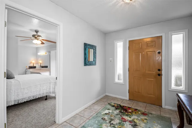 a bedroom with a bed and a large window