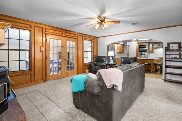 a living room with furniture large window and flat screen tv
