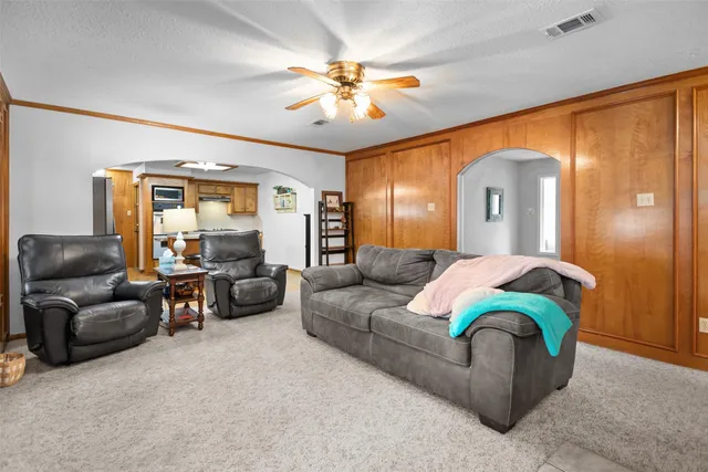 a living room with furniture and a chandelier