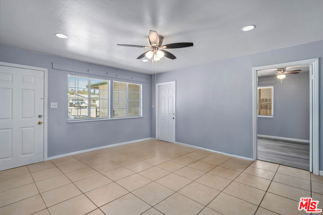 15872 Rexroth Drive Mojave, CA 93501 - Photo 4 of 20 a view of an empty room with window and chandelier fan