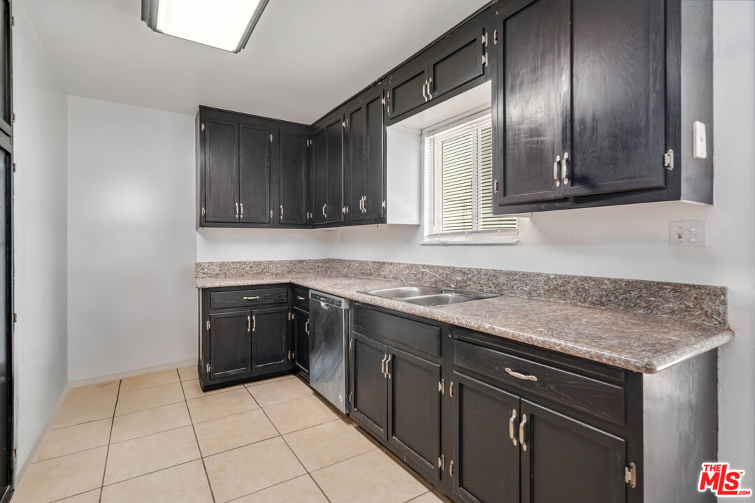 15872 Rexroth Drive Mojave, CA 93501 - Photo 7 of 20 a kitchen with a sink a stove and cabinets