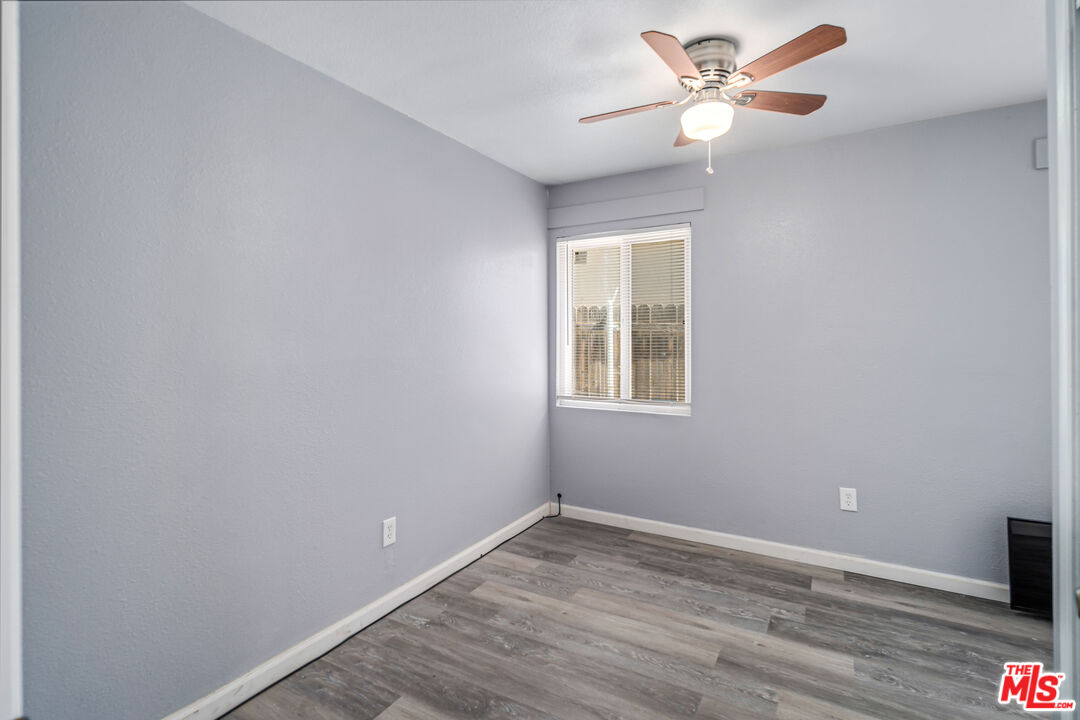 15872 Rexroth Drive Mojave, CA 93501 - Photo 10 of 20 a view of an empty room with a window and wooden floor