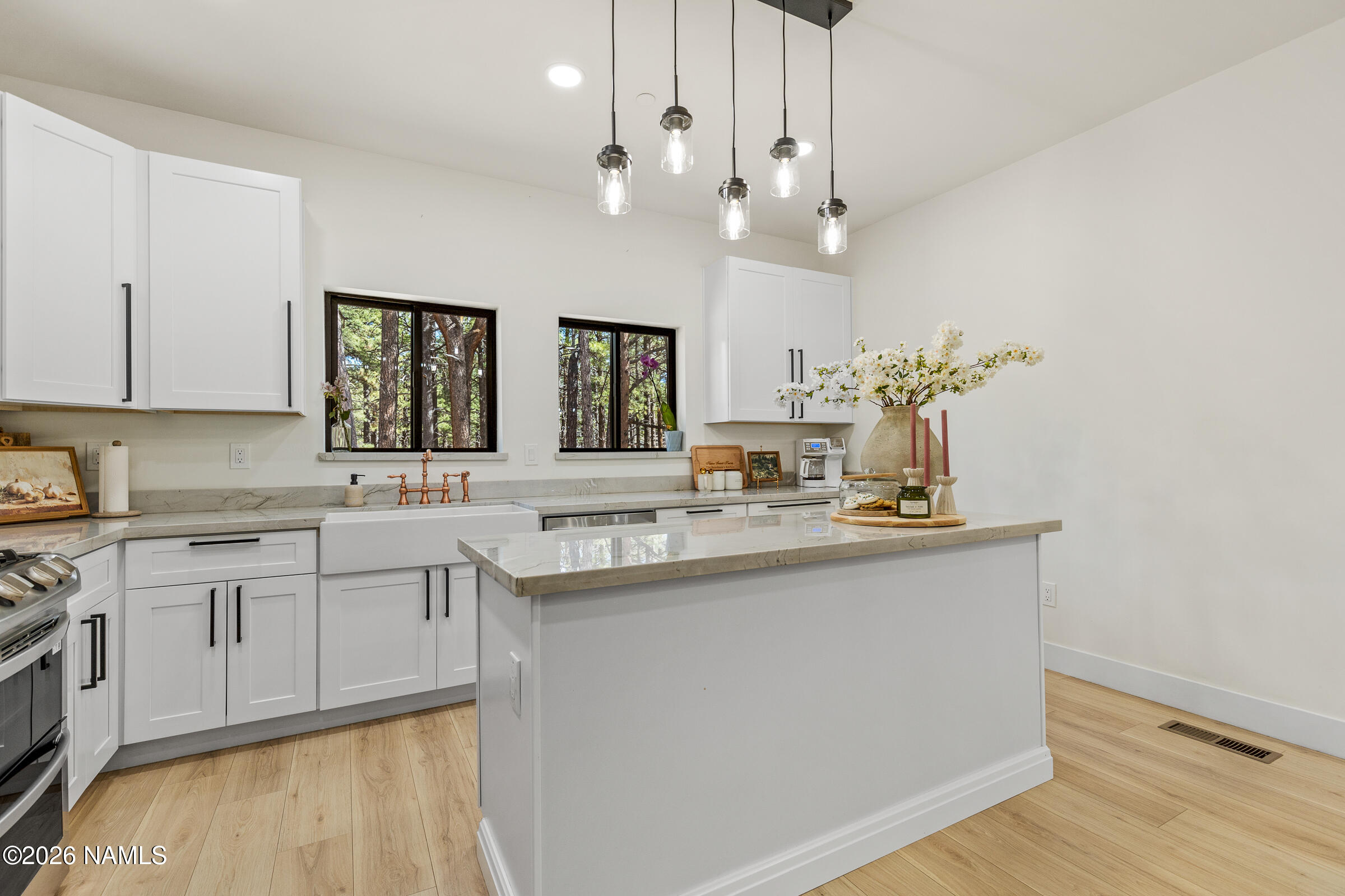 1113 Redwall Way Williams, AZ 86046 - Photo 11 of 53 a kitchen with center island white cabinets and sink