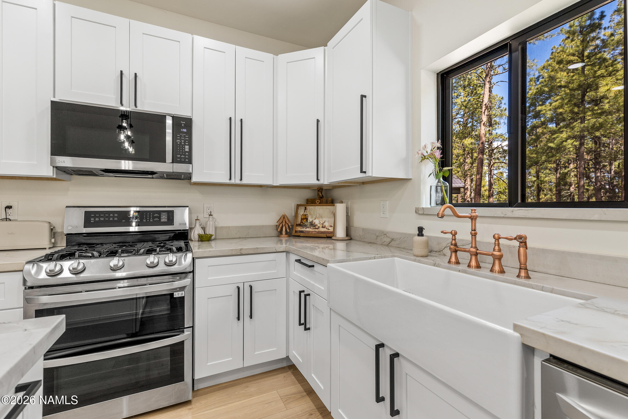 1113 Redwall Way Williams, AZ 86046 - Photo 15 of 53 a kitchen with stainless steel appliances a stove a sink and a microwave