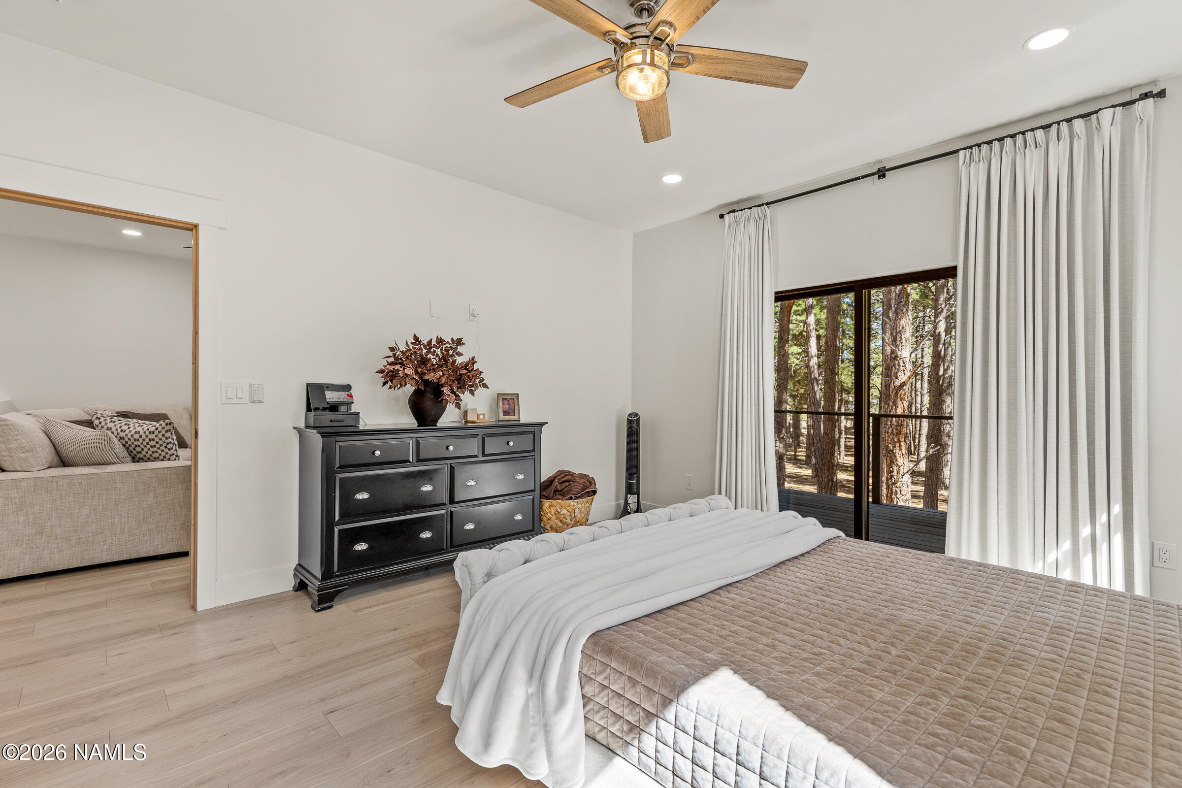 1113 Redwall Way Williams, AZ 86046 - Photo 19 of 53 a bedroom with a bed and a chandelier