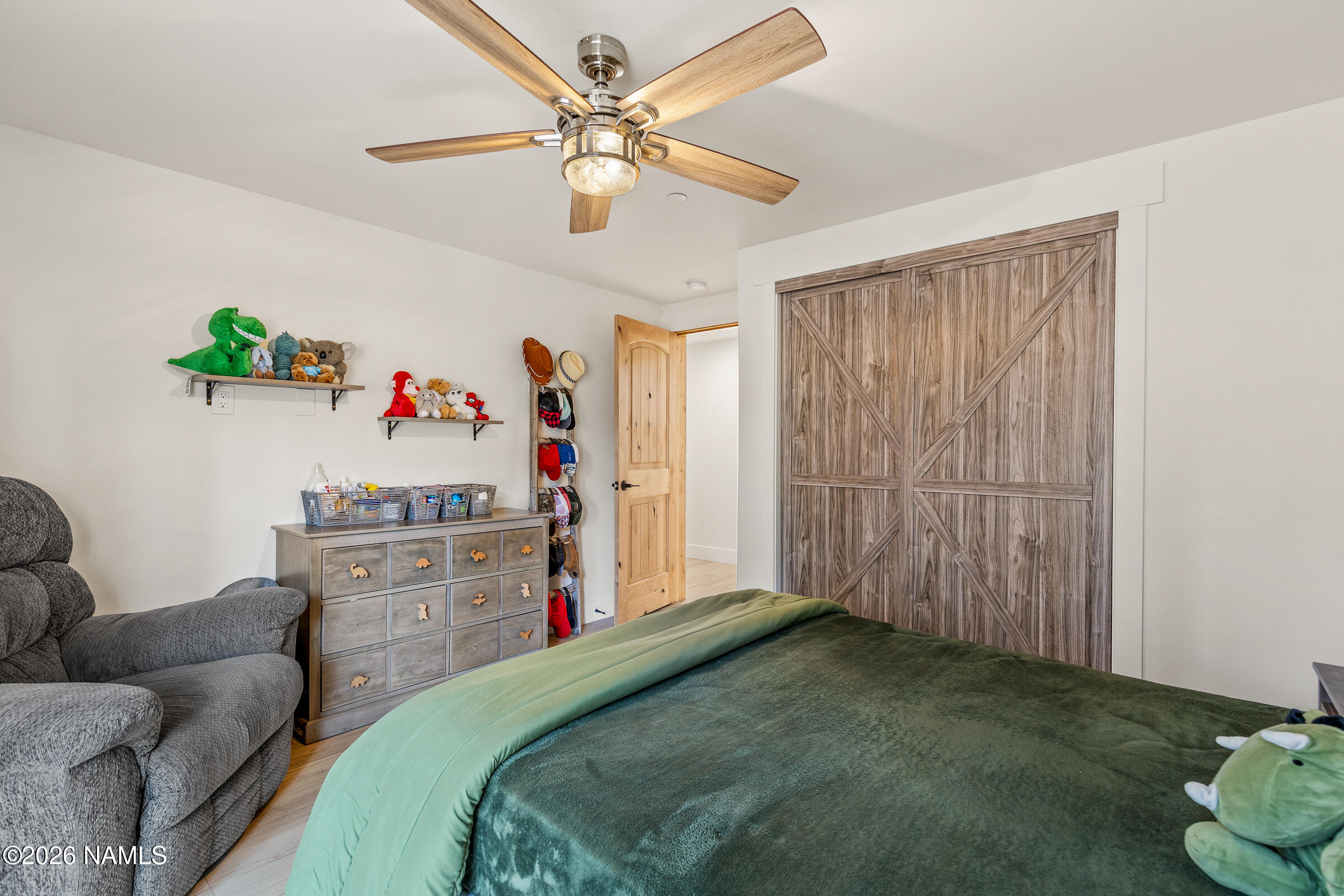 1113 Redwall Way Williams, AZ 86046 - Photo 27 of 53 a bedroom with a bed and a chandelier