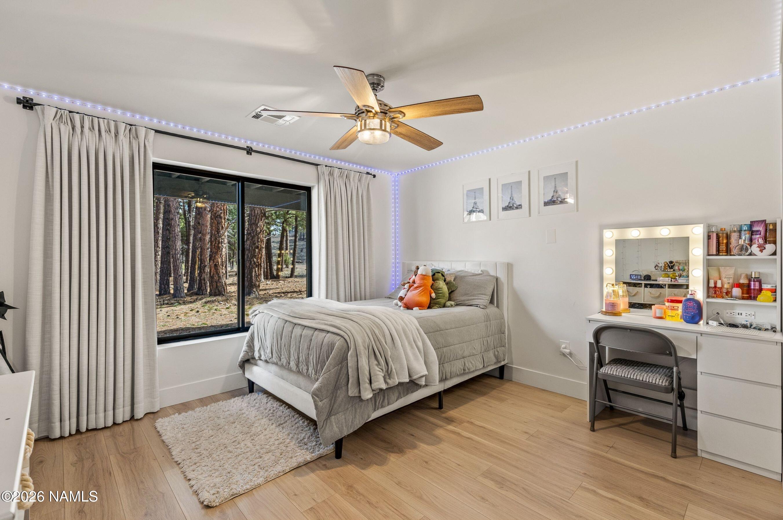 1113 Redwall Way Williams, AZ 86046 - Photo 28 of 53 a bedroom with a bed and a chandelier