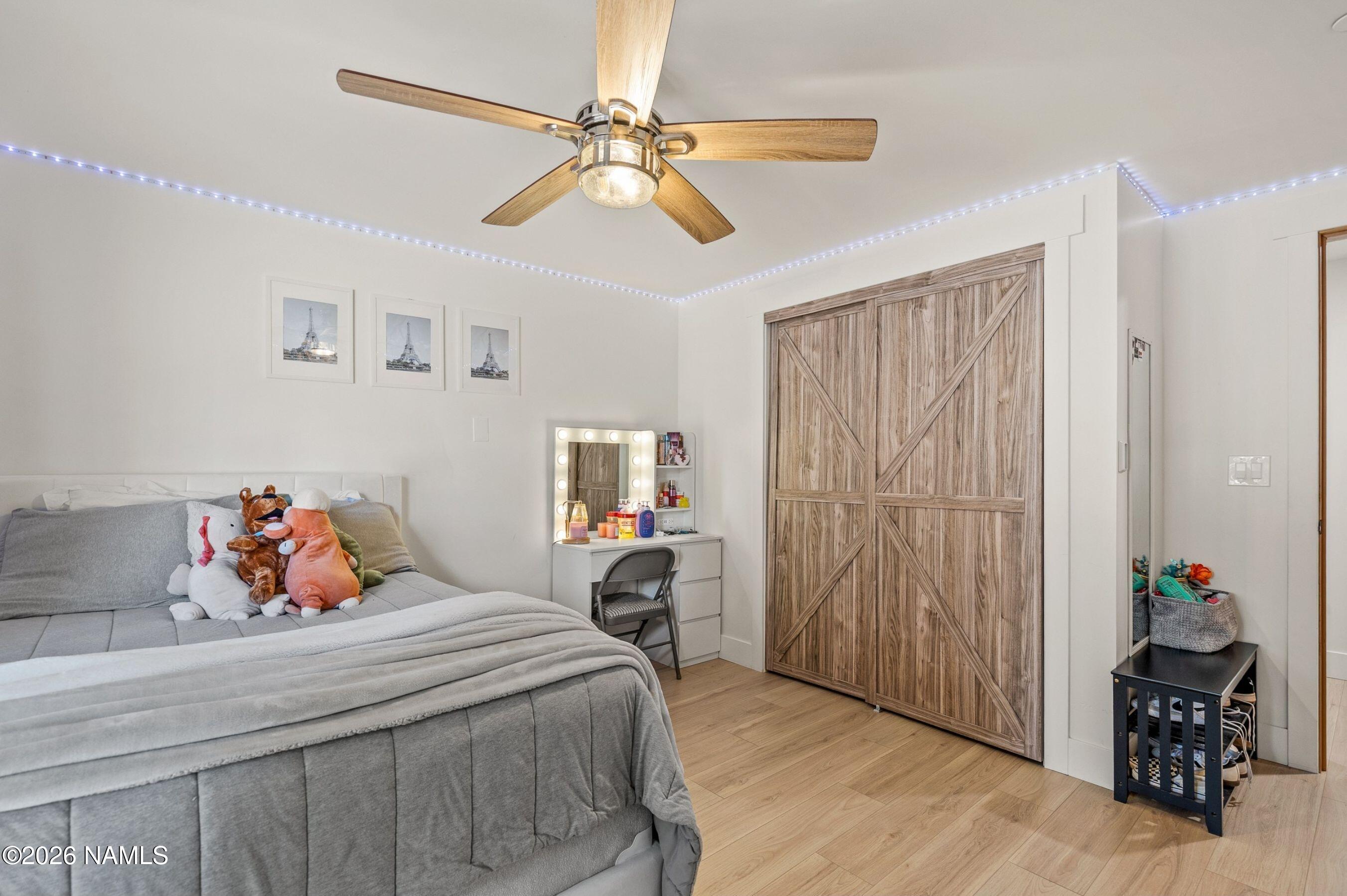 1113 Redwall Way Williams, AZ 86046 - Photo 29 of 53 a bedroom with a bed and a chandelier