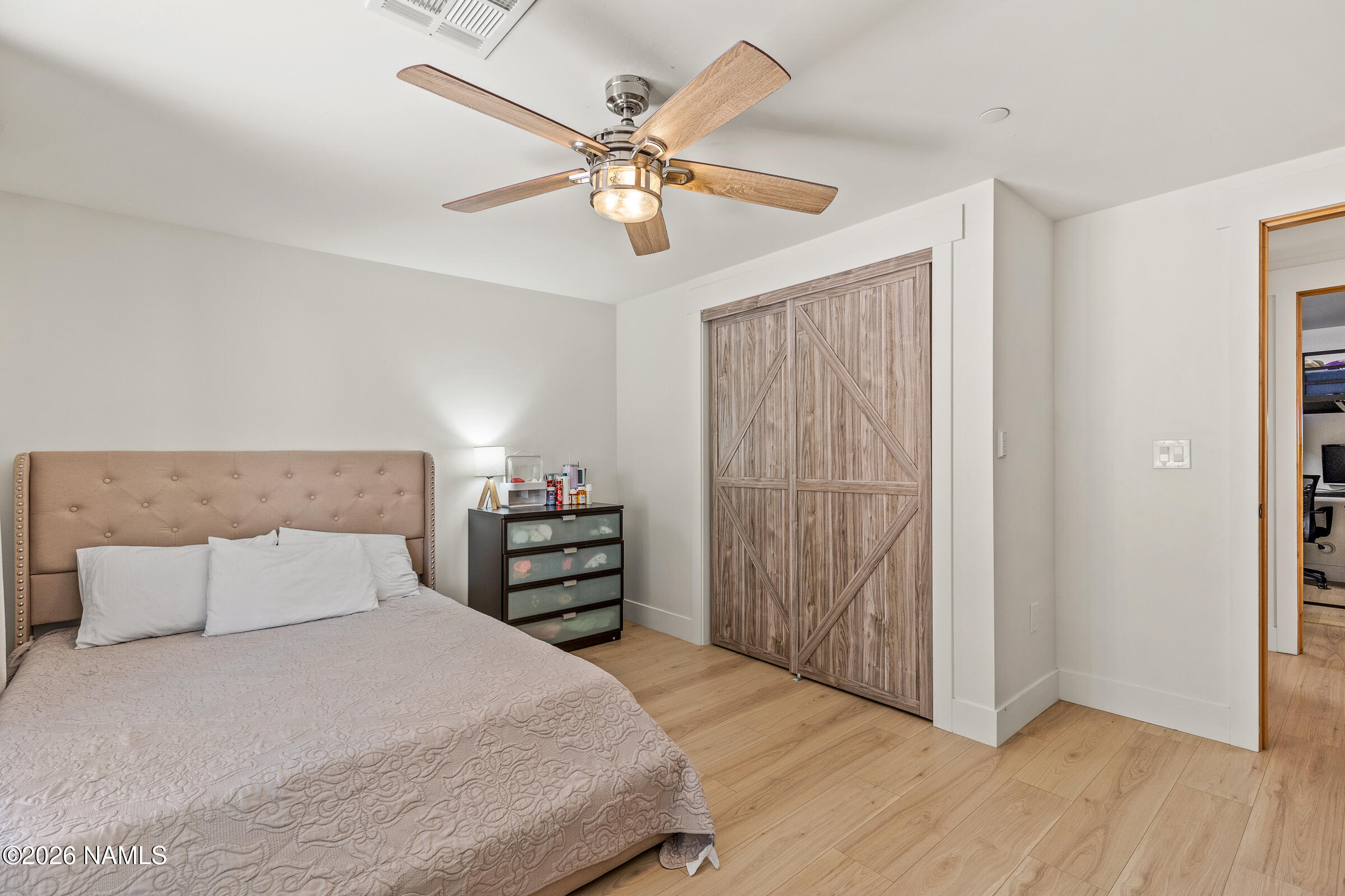 1113 Redwall Way Williams, AZ 86046 - Photo 32 of 53 a bedroom with a bed and a chandelier