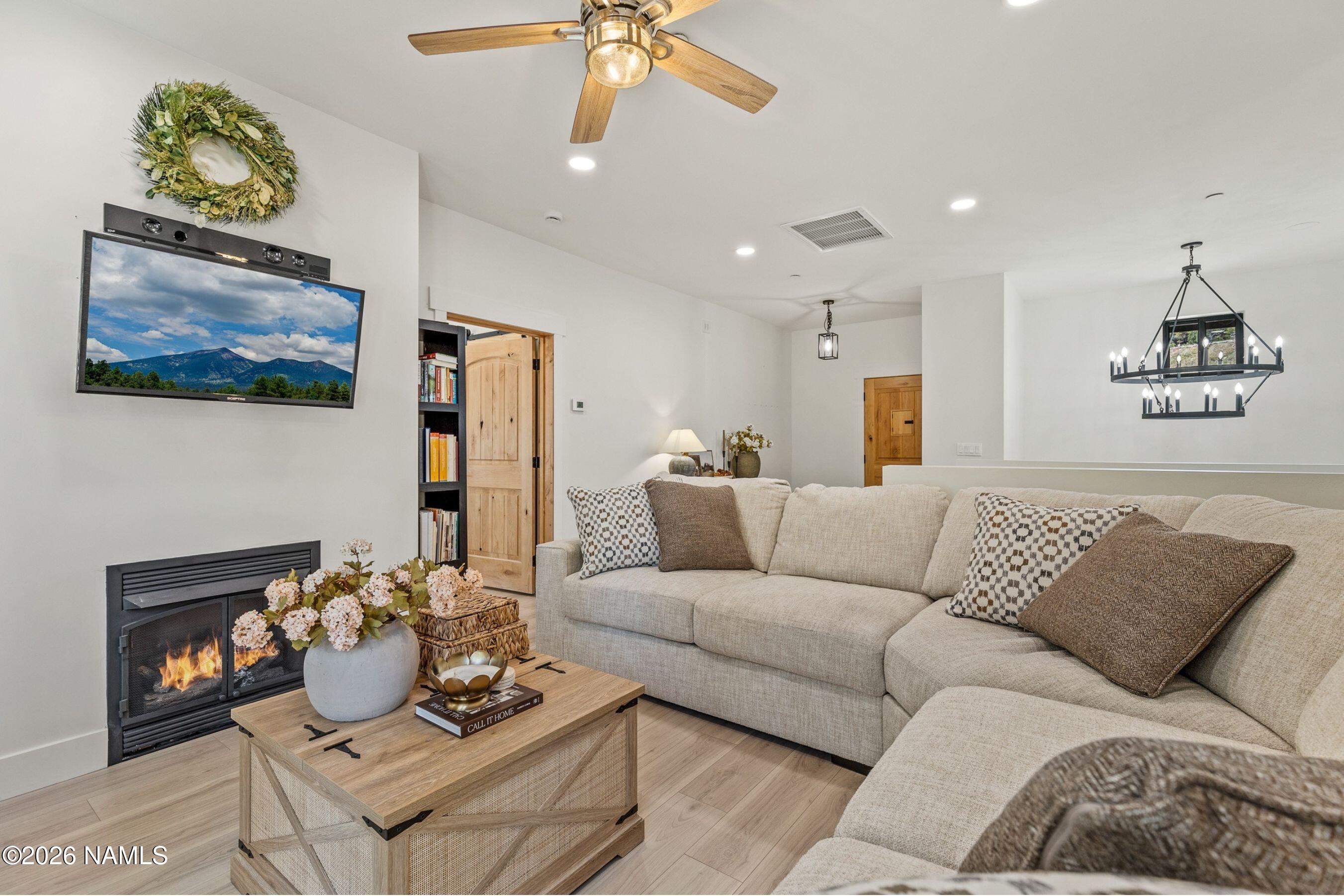 1113 Redwall Way Williams, AZ 86046 - Photo 7 of 53 a living room with furniture and a chandelier