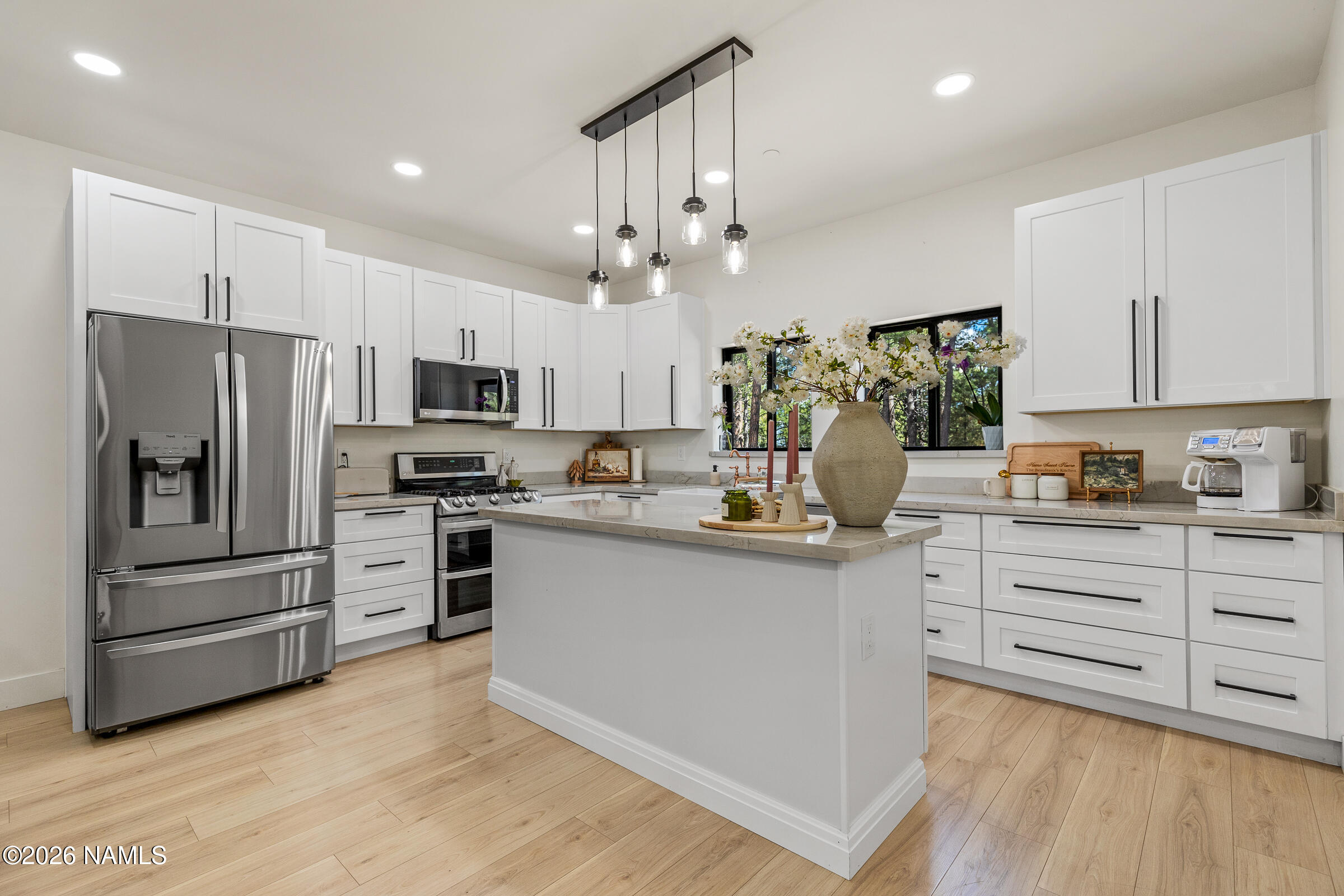 1113 Redwall Way Williams, AZ 86046 - Photo 10 of 53 a kitchen with kitchen island white cabinets and stainless steel appliances