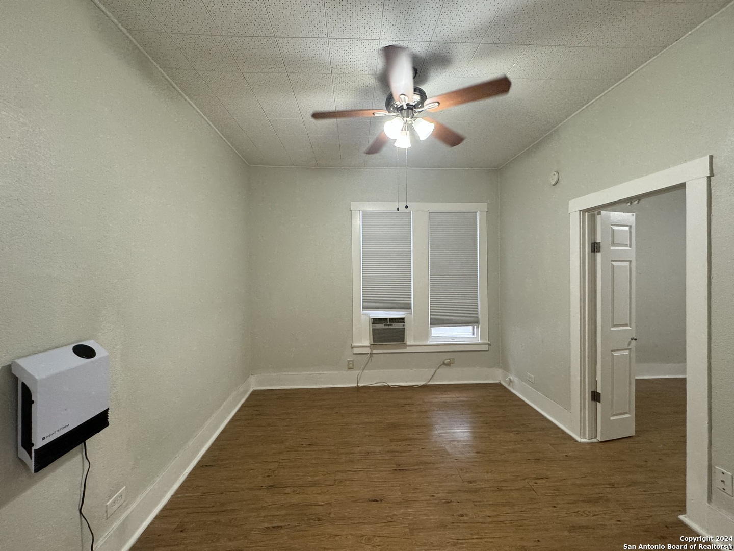 407 East Locust Street, Unit 2 San Antonio, TX 78212 - Photo 4 of 7 a view of an empty room with window and wooden floor