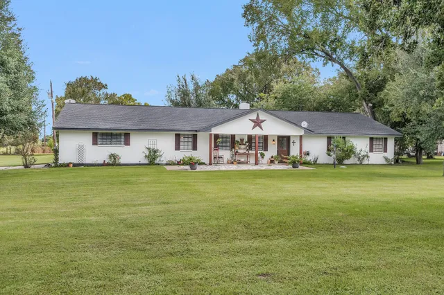 a front view of a house with swimming pool having outdoor seating
