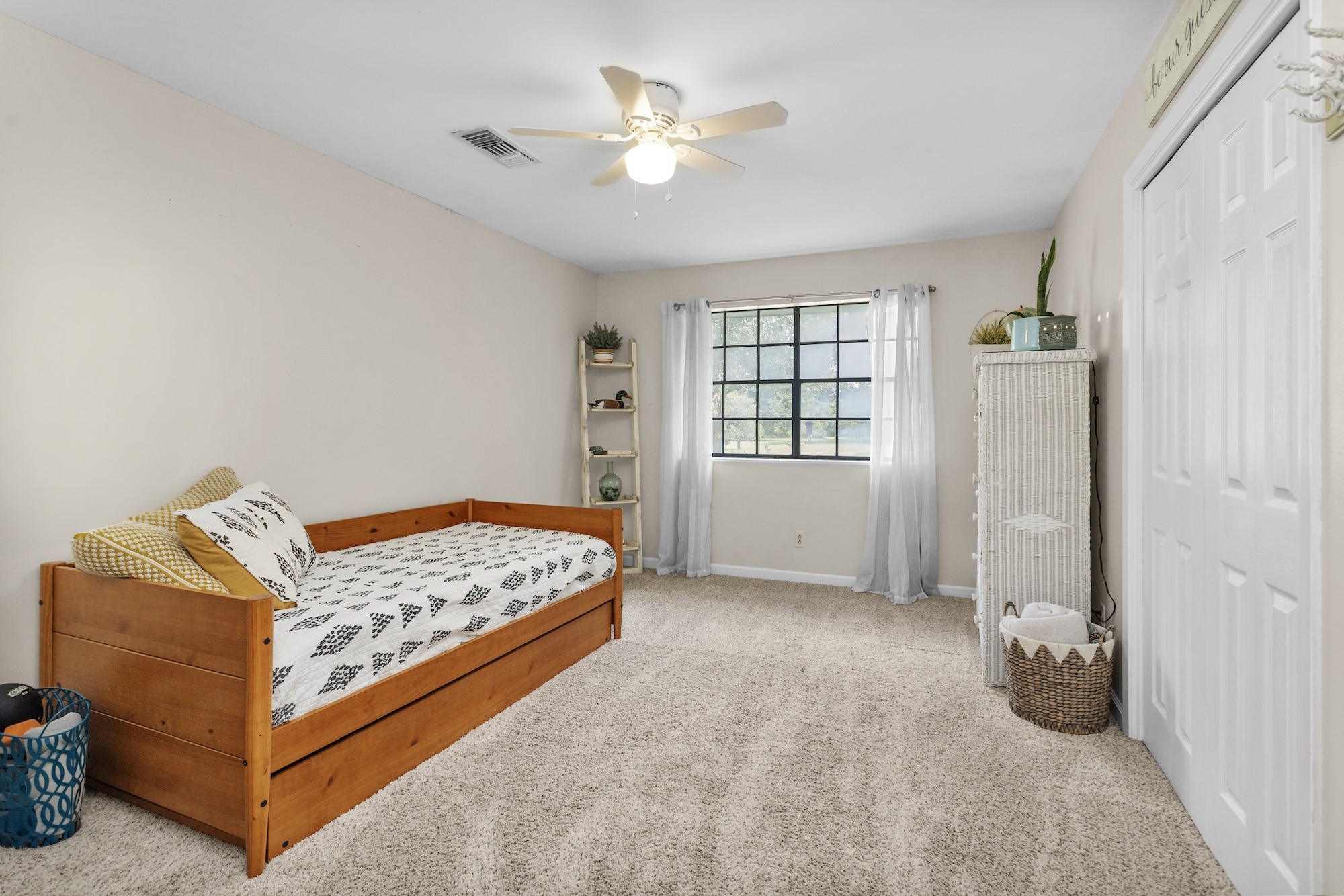 21251 Old River Road Washington, TX 77880 - Photo 11 of 20 a bedroom with a bed and a ceiling fan