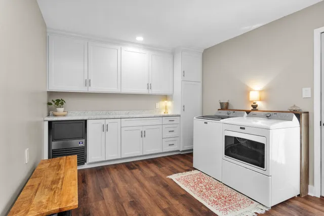 a kitchen with a stove cabinets and wooden floor