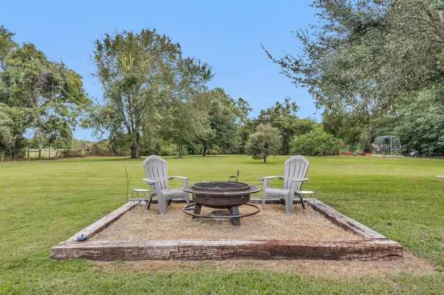 a view of a lake with a table and chair in the patio