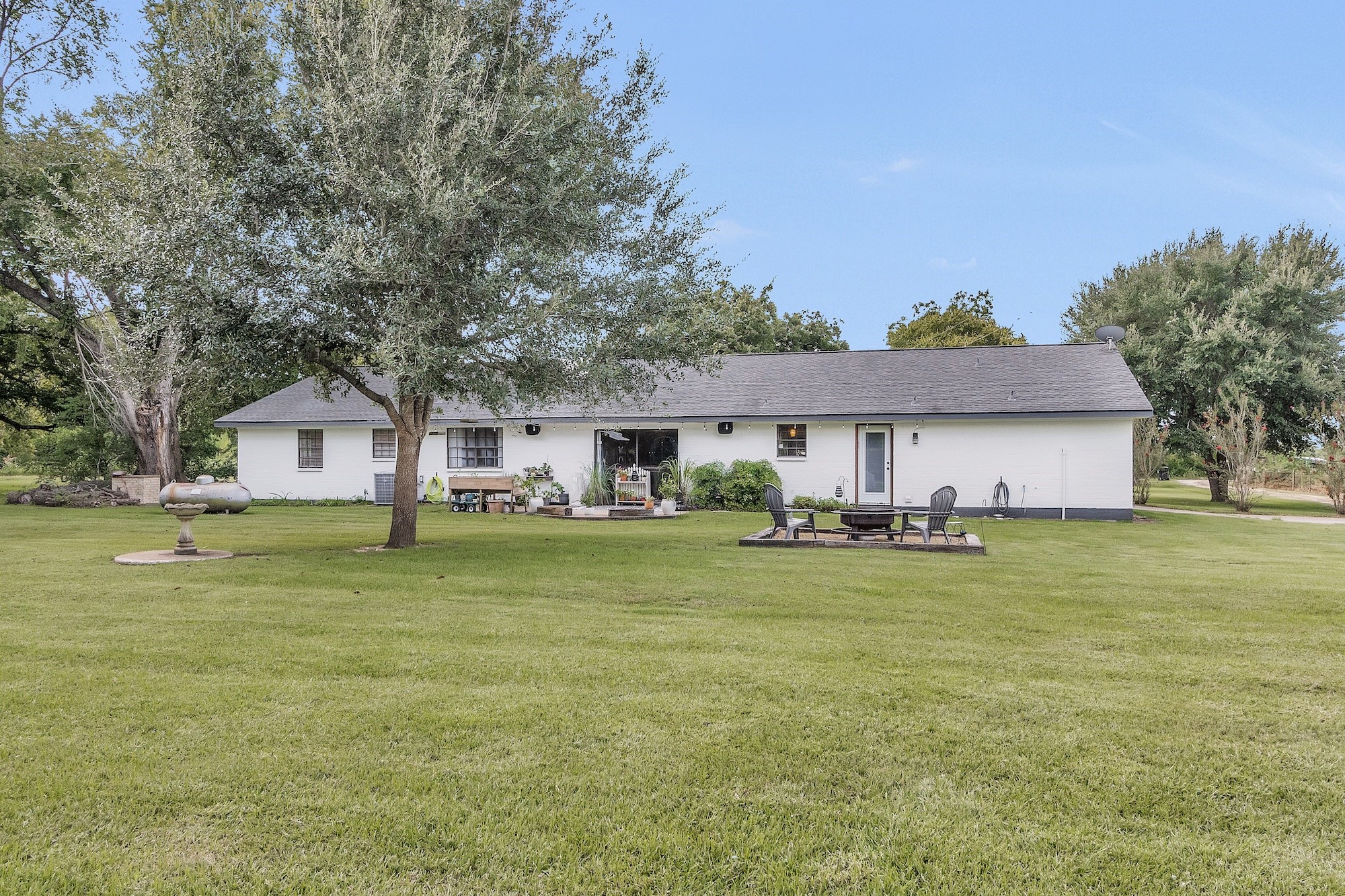 21251 Old River Road Washington, TX 77880 - Photo 18 of 20 a front view of a house with a garden and deck