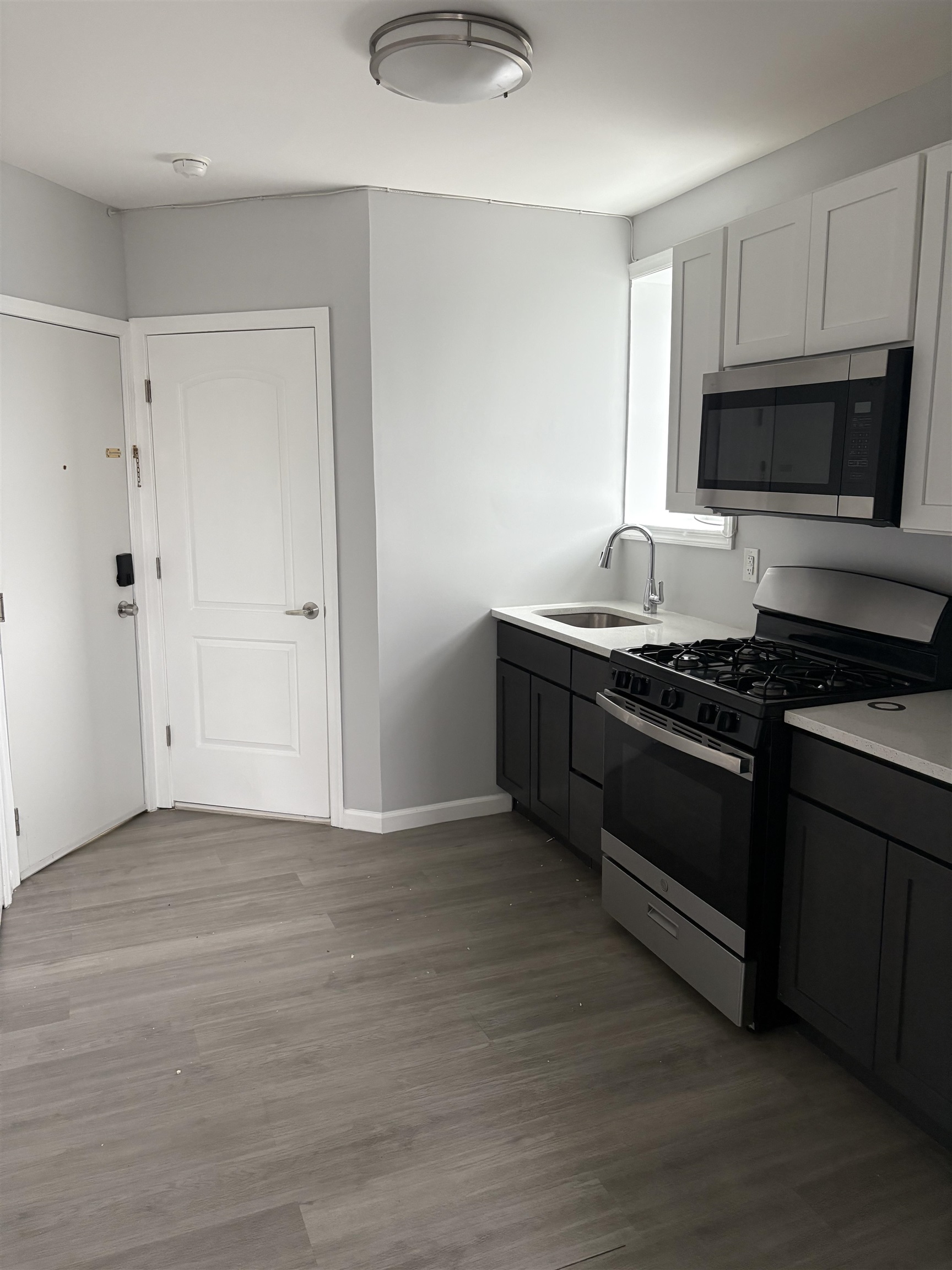 a kitchen with stainless steel appliances granite countertop a stove and a microwave