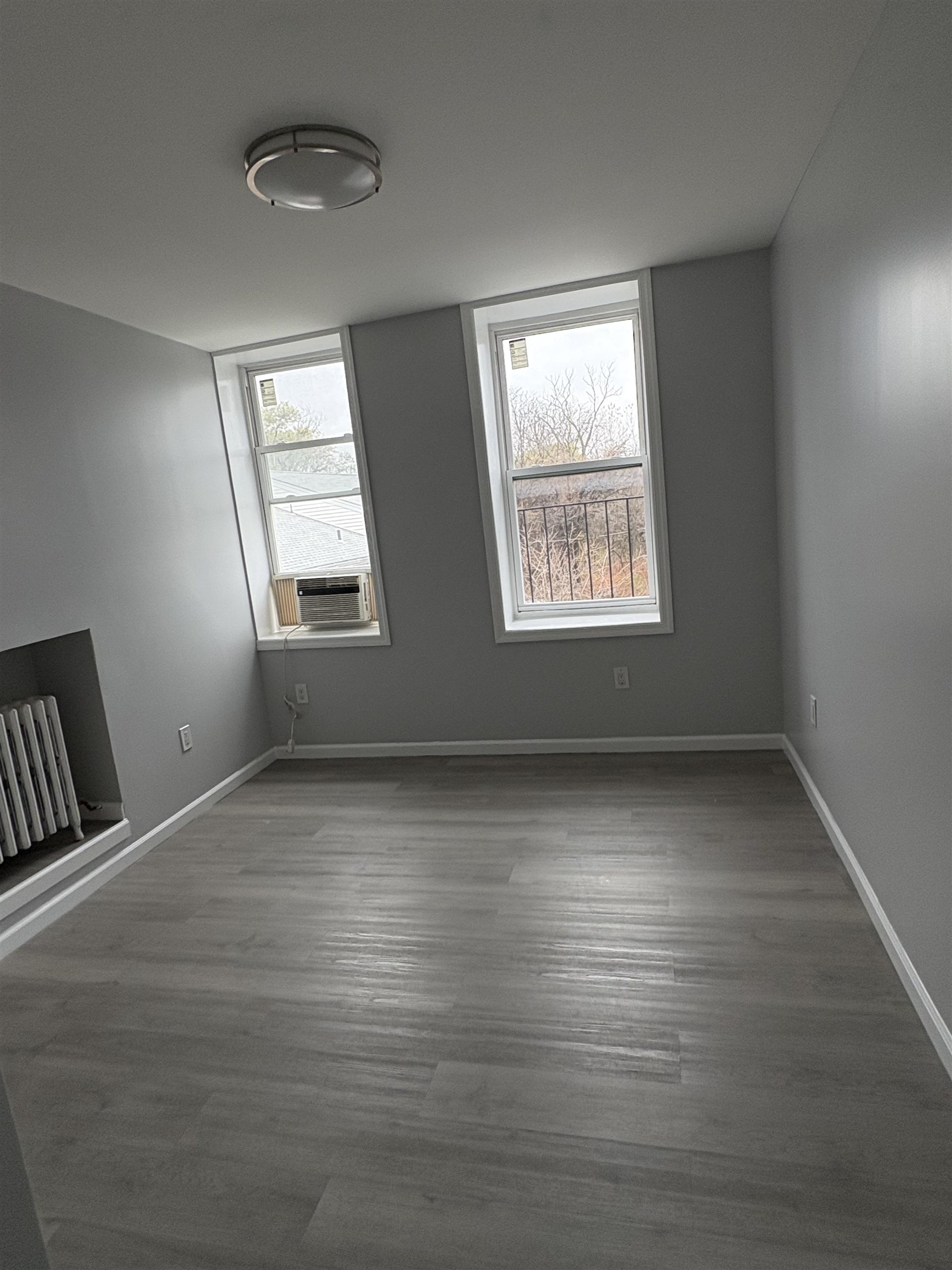 17 Teaneck Road, Unit 3A Ridgefield Park, NJ 07660 - Photo 7 of 8 an empty room with wooden floor and windows