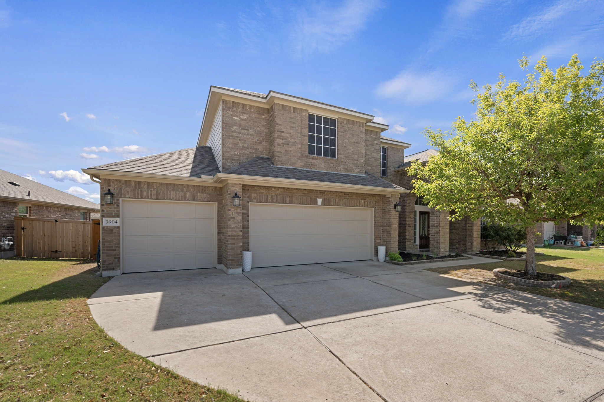 3904 Brean Down Road Pflugerville, TX 78660 - Photo 1 of 40 Traditional-style house with brick siding, a shingled roof, driveway, and a garage