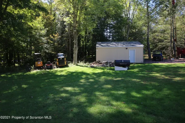 a view of a house with a yard and sitting area