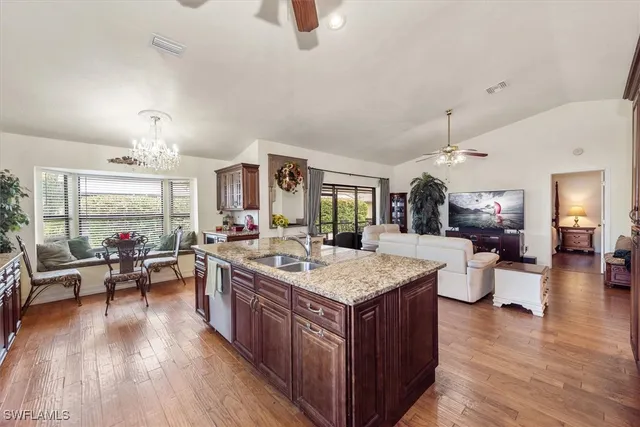 a large kitchen with a table chairs and wooden floor