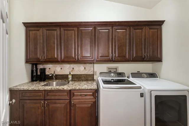a kitchen with granite countertop a sink stove and cabinets