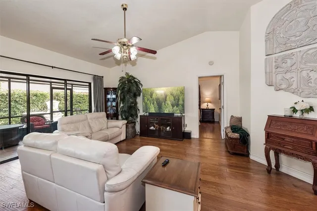 a living room with furniture a fireplace and a chandelier
