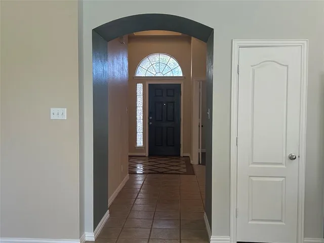 a view of a entryway door with a hallway