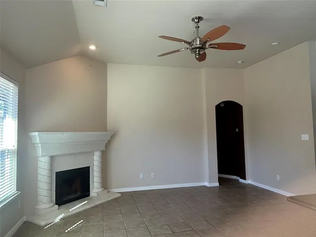 a view of a livingroom with a ceiling fan and window