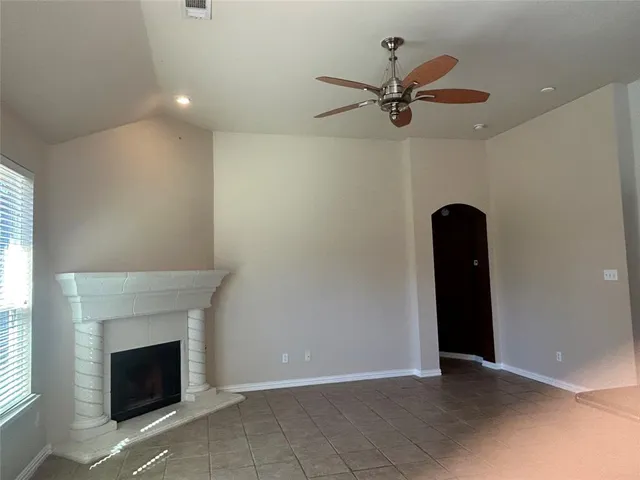a view of a livingroom with a ceiling fan and window