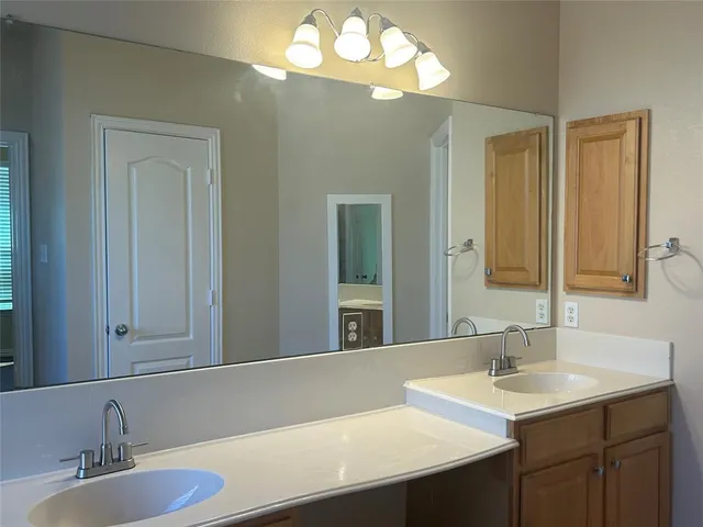 a bathroom with a sink a vanity and a mirror