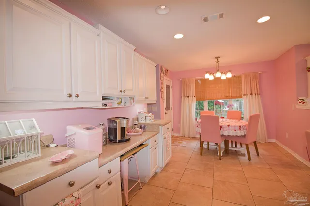 a kitchen with kitchen island a sink table and chairs