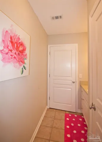 a bedroom with a bed and a lamp