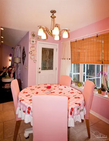 a large kitchen with lots of counter space and chairs