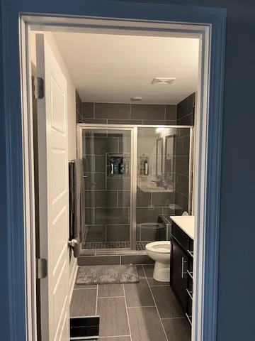 a bathroom with a shower toilet and sink