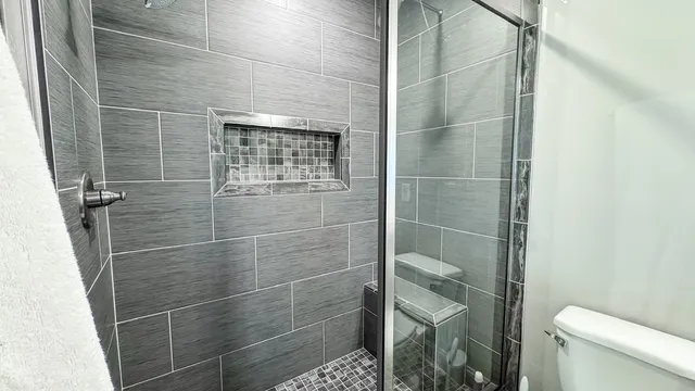 a living room with furniture and a baby crib