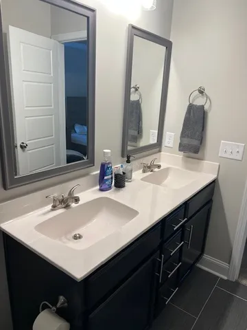 a bathroom with a sink vanity and a mirror
