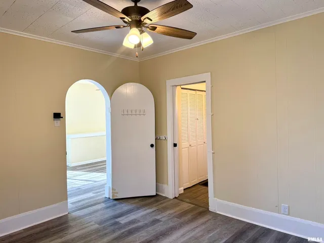 a view of an empty room with wooden floor