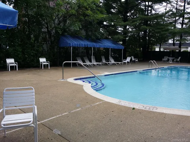 a view of a swimming pool with sitting area