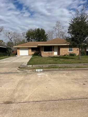 front view of house next to a yard