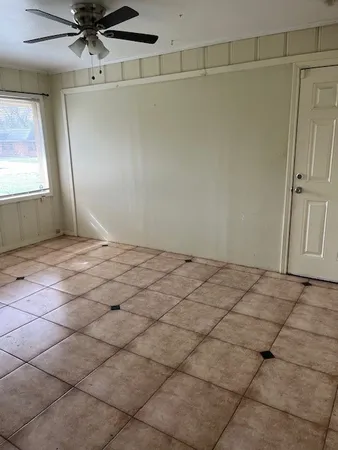 a view of a room with a sink and cabinets