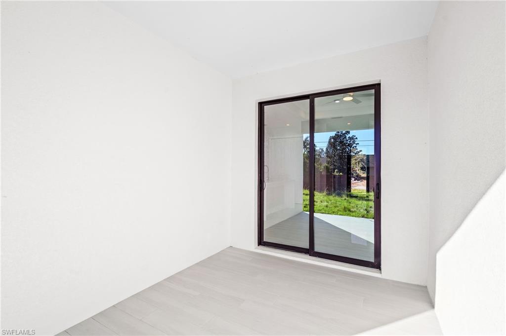 2064 55th Terrace Southwest Naples, FL 34116 - Photo 11 of 30 Empty room featuring light wood-style flooring