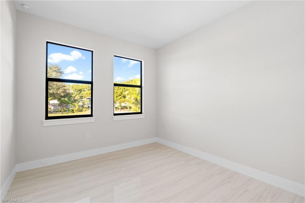2064 55th Terrace Southwest Naples, FL 34116 - Photo 18 of 30 Spare room featuring baseboards
