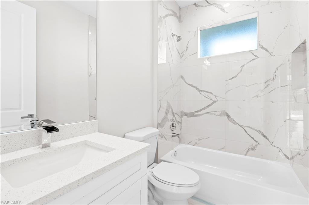 2064 55th Terrace Southwest Naples, FL 34116 - Photo 20 of 30 Full bath with vanity and washtub / shower combination