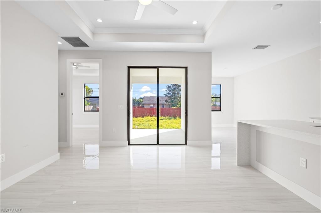 2064 55th Terrace Southwest Naples, FL 34116 - Photo 23 of 30 Spare room featuring ceiling fan, a raised ceiling, crown molding, and recessed lighting